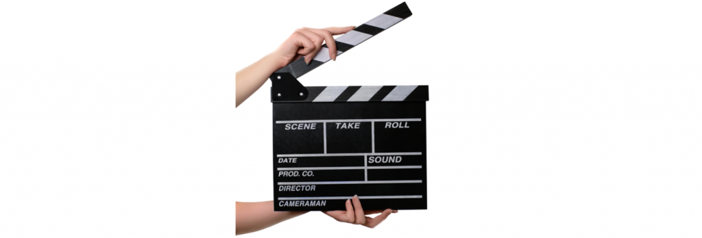 Hands holding a movie clapper board ready to start a new take